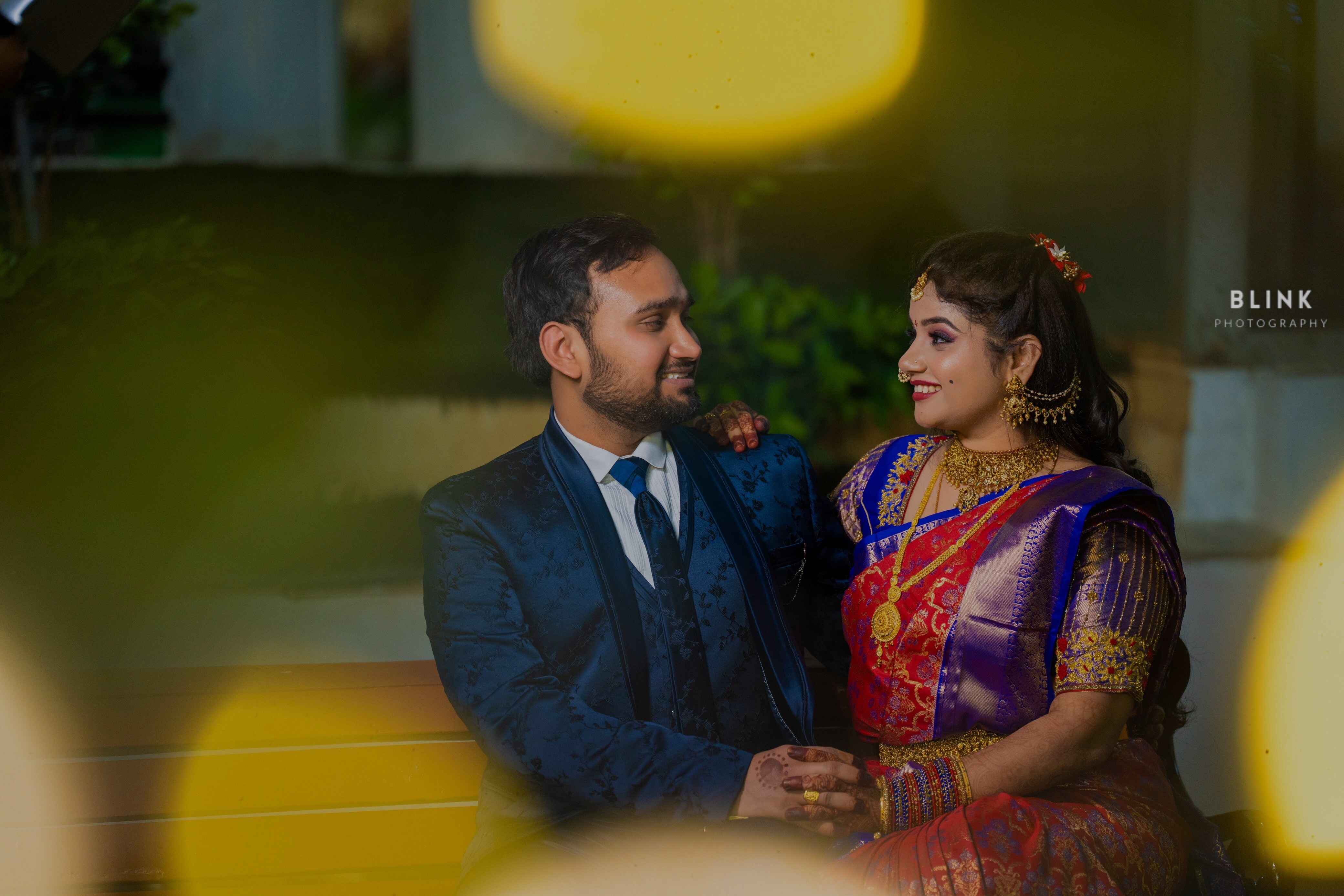 A cinematic picture of a couple with a colorful candilight setting