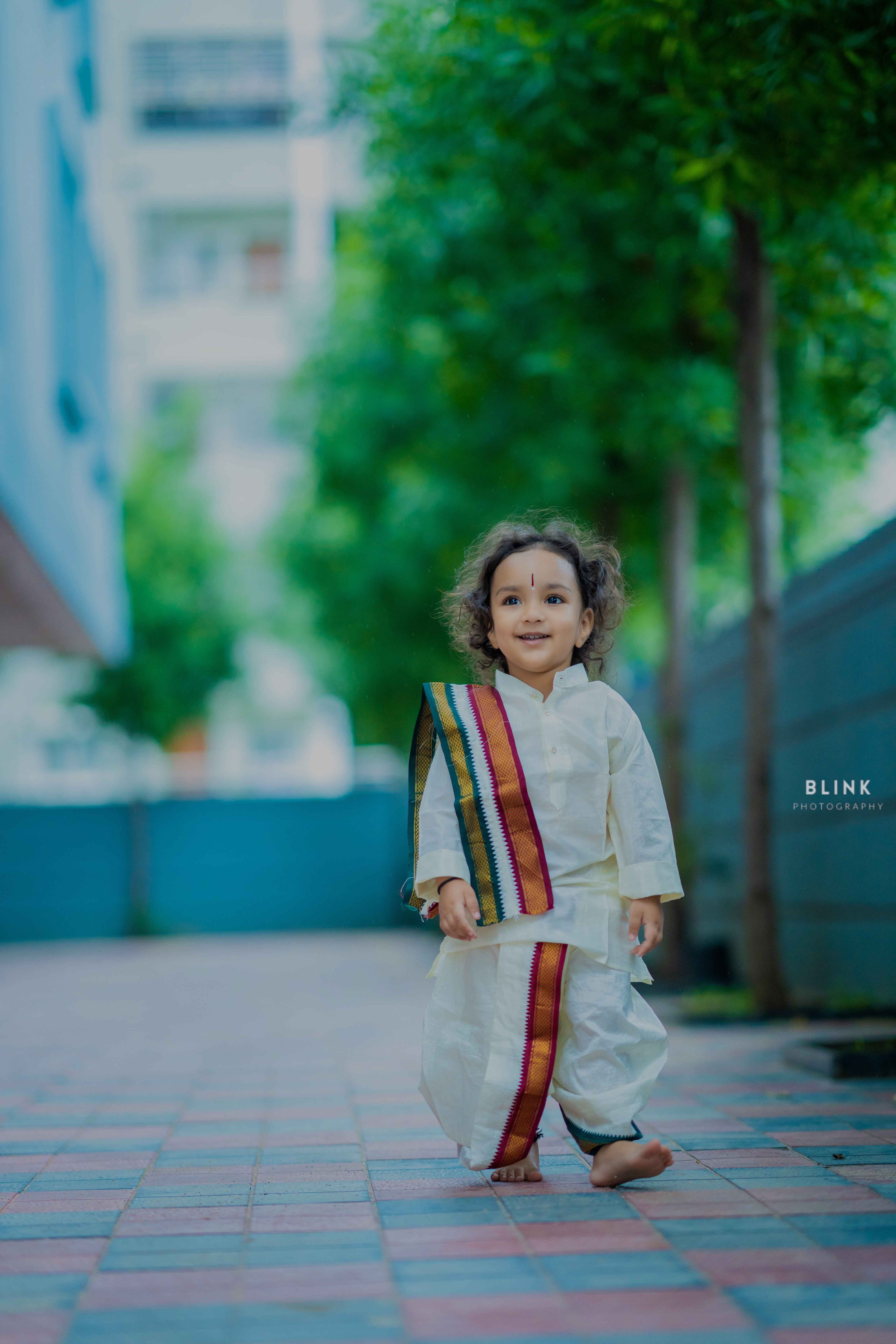 A picture of cute baby with Indian culture outfit pancha & tanduva